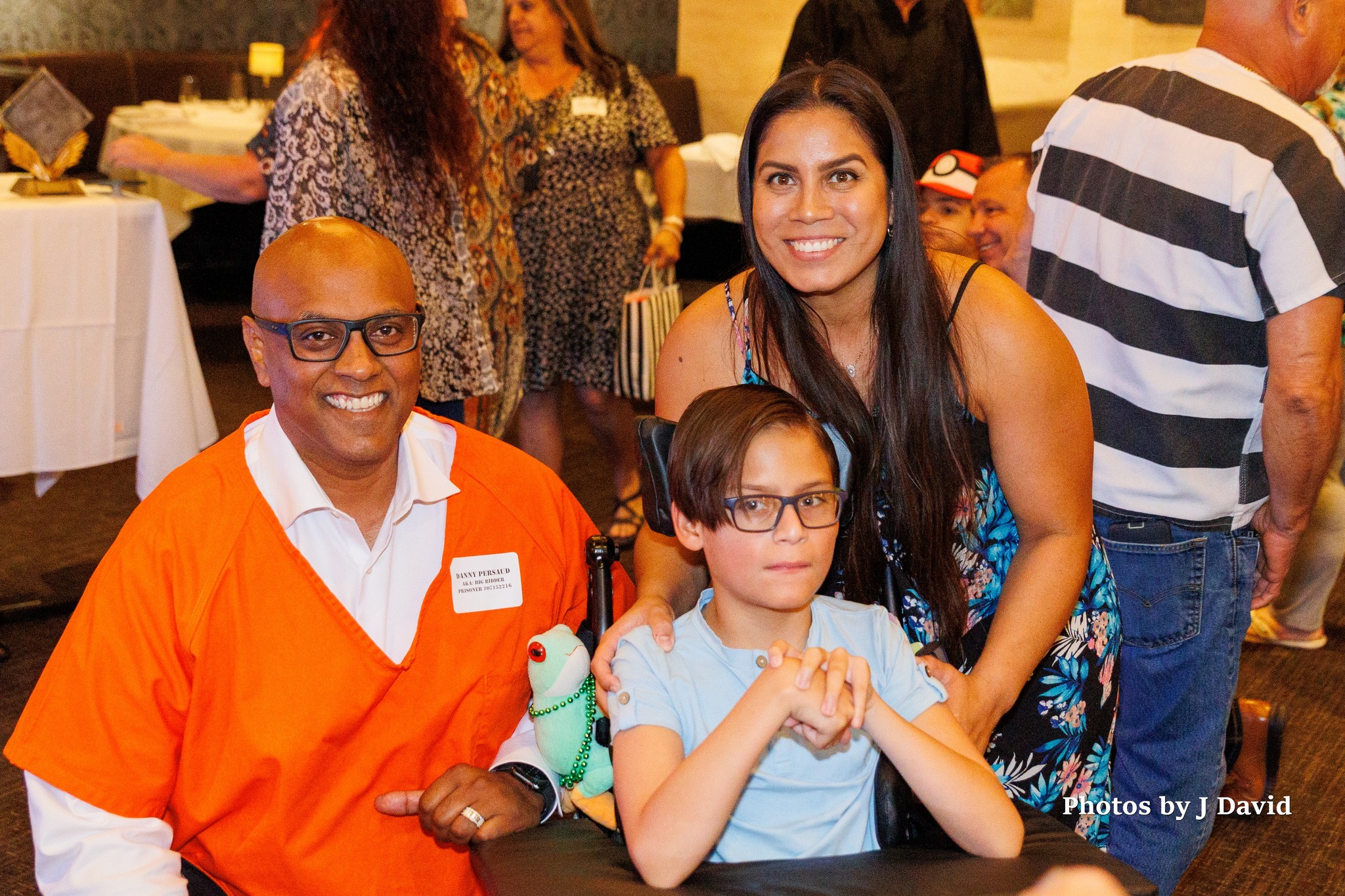 Danny Persaud poses for photo with a Wheel Kid family at the 2022 Wheelchairs 4 Kids Jail & Bail Fundraiser